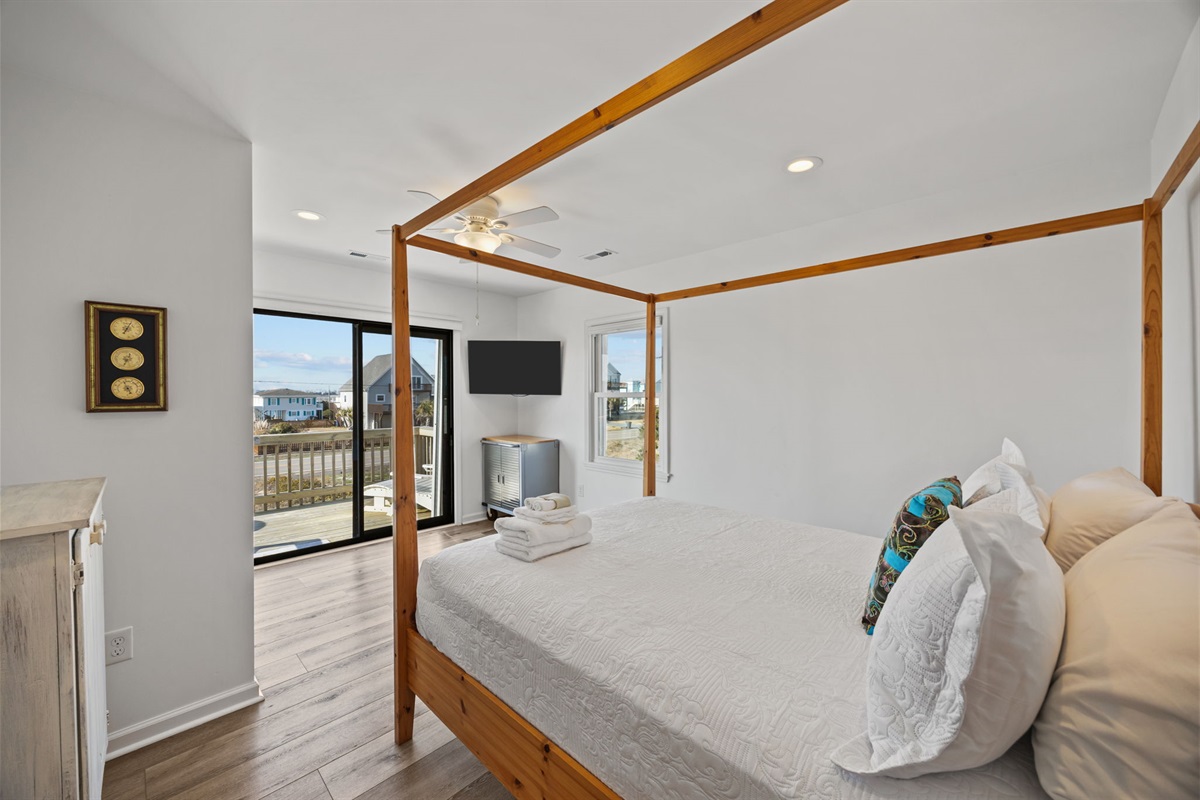 Inviting second-floor bedroom with a canopy bed and calm coastal style