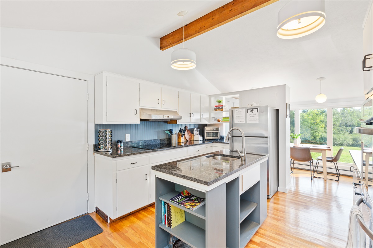 Kitchen with new granite counters, induction stove top including coffee and basic spices