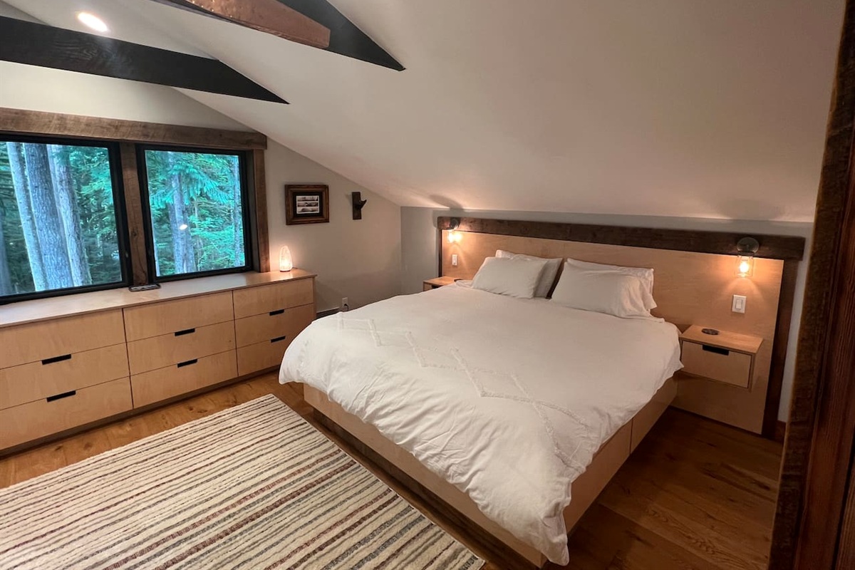 King bed master suite with tranquil view, copper detail and vaulted ceiling