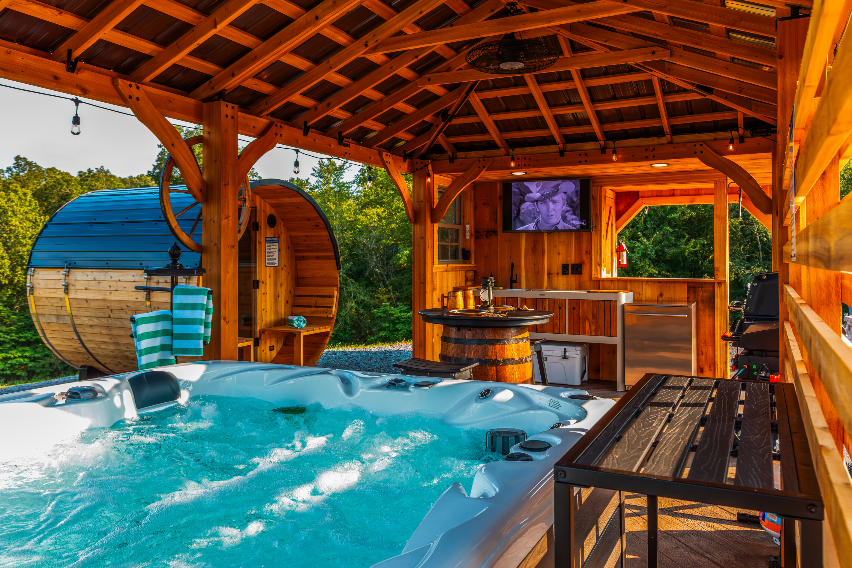 Relax in the hot tub while enjoying the outdoor TV, sauna, and covered pavilion setting.
