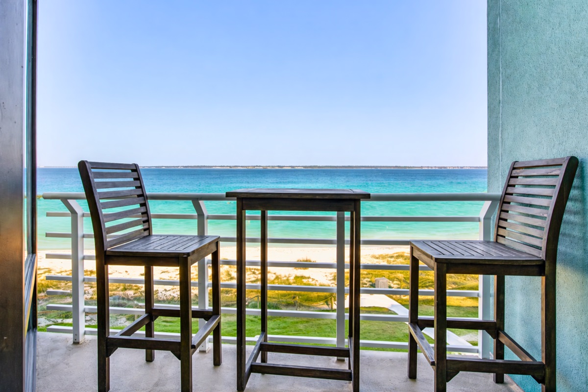 Enjoy meals or drinks outdoors with a table set against a beautiful water backdrop.