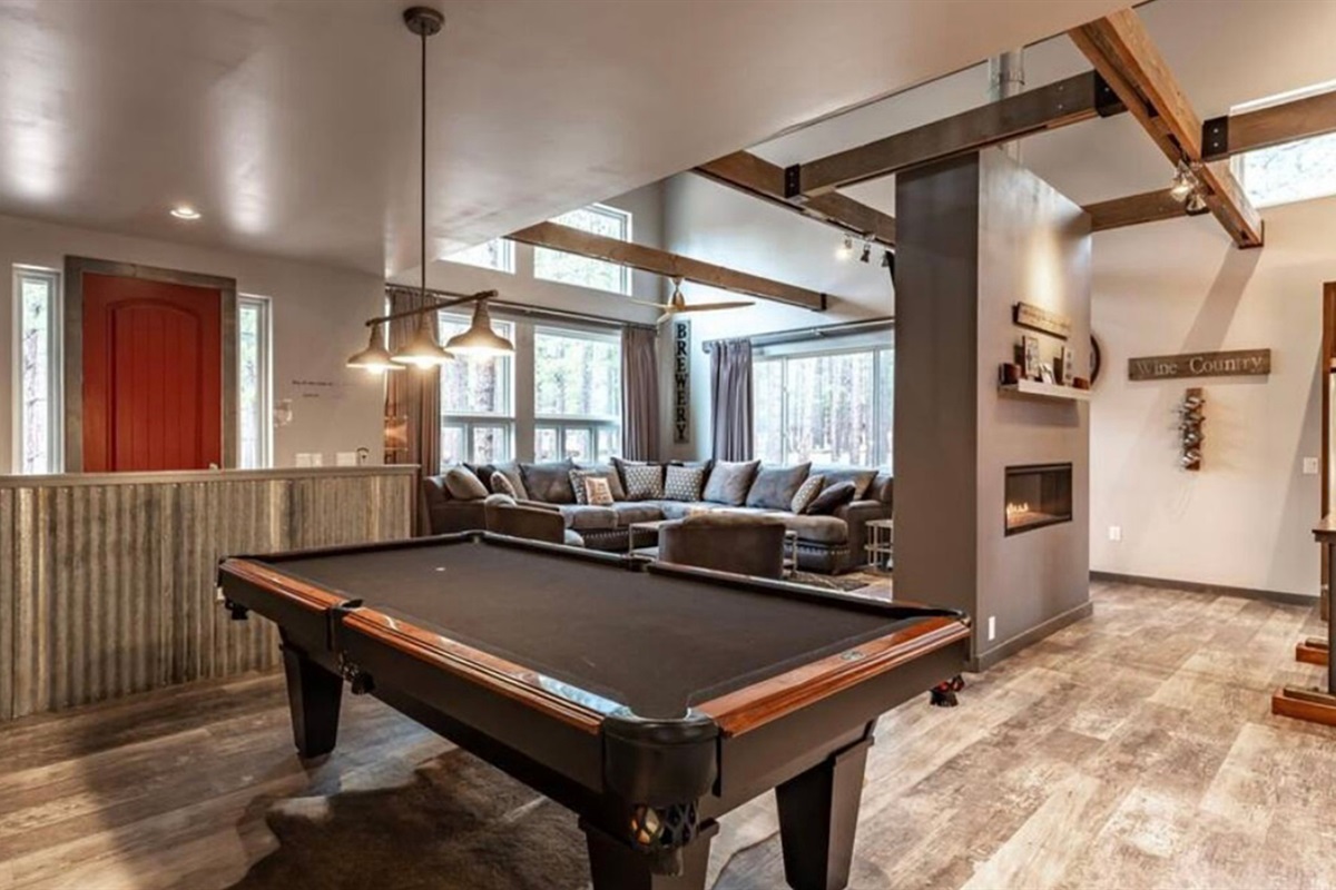 Game room with pool table and open layout connecting to the main living space.