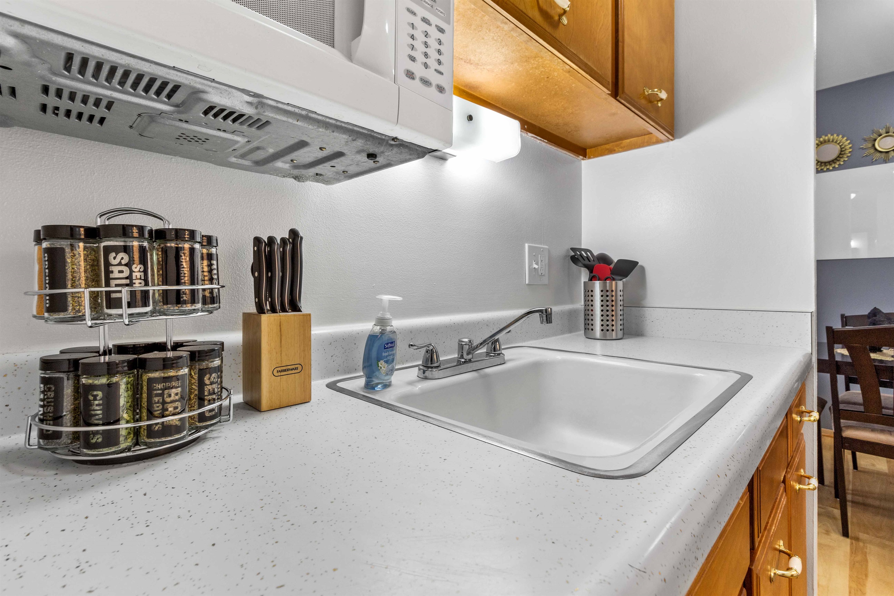 Knife block, spice rack, coffee, creamer, sugar and tea.