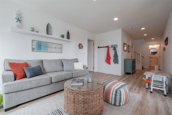 A cozy second living space with curated games, books, and DVDs in the blue cabinet—perfect for unwinding together!