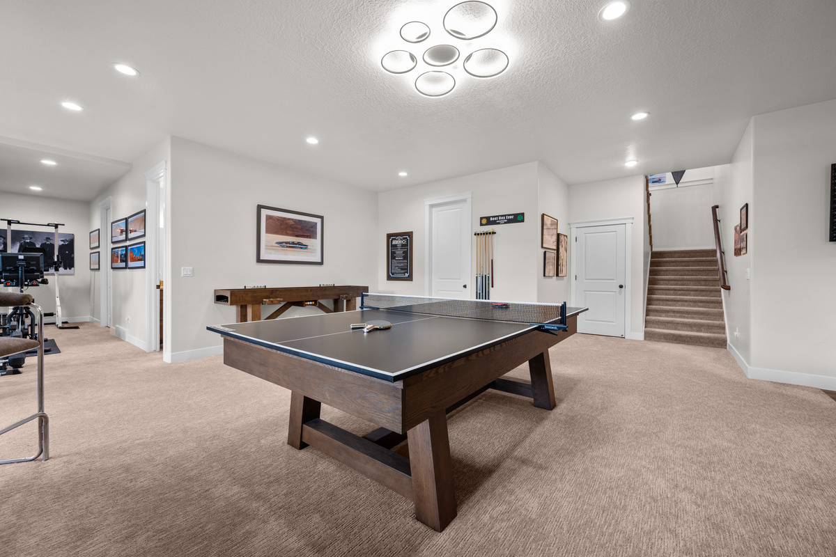 Spacious game room with ping pong table, fitness area, and plenty of room for family fun.