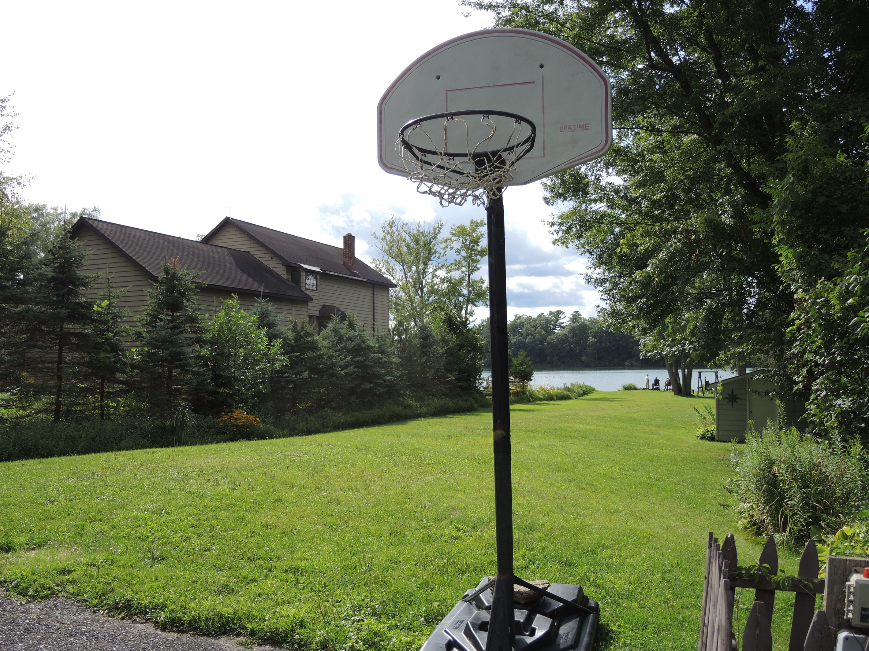 Basketball hoop and lawn leading to water