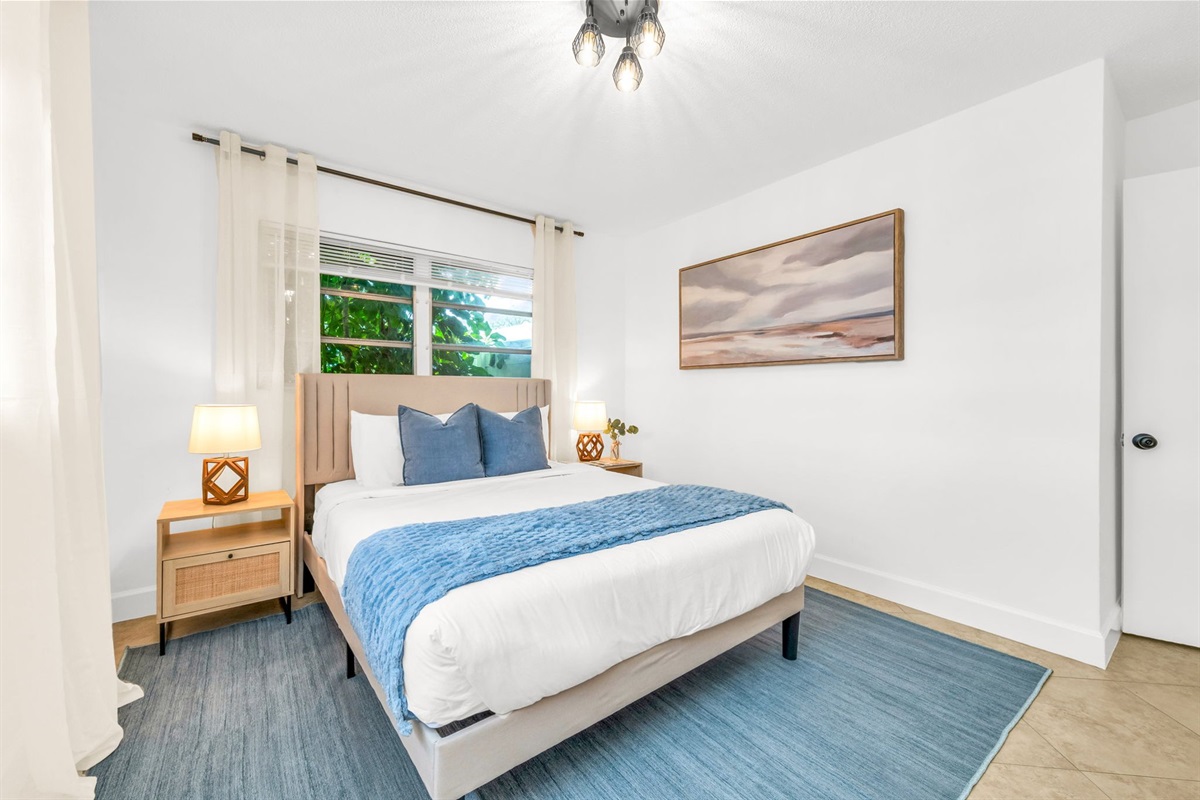 3rd Bedroom: Relax in this stylish queen bedroom with a comfortable queen bed, chic modern accents, and thoughtfully curated décor. The room is designed for comfort and convenience, offering a cozy and serene space to unwind.