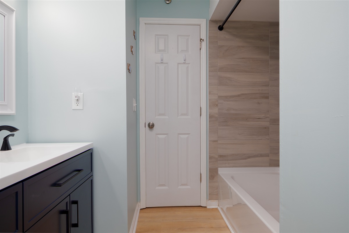 Hallway bathroom with tub