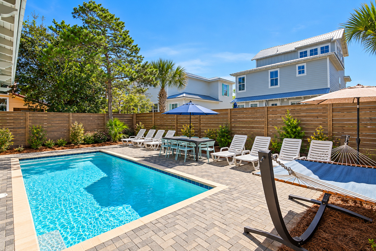 The private pool area features lounges, poolside tables and chairs, a hammock, and a grill.