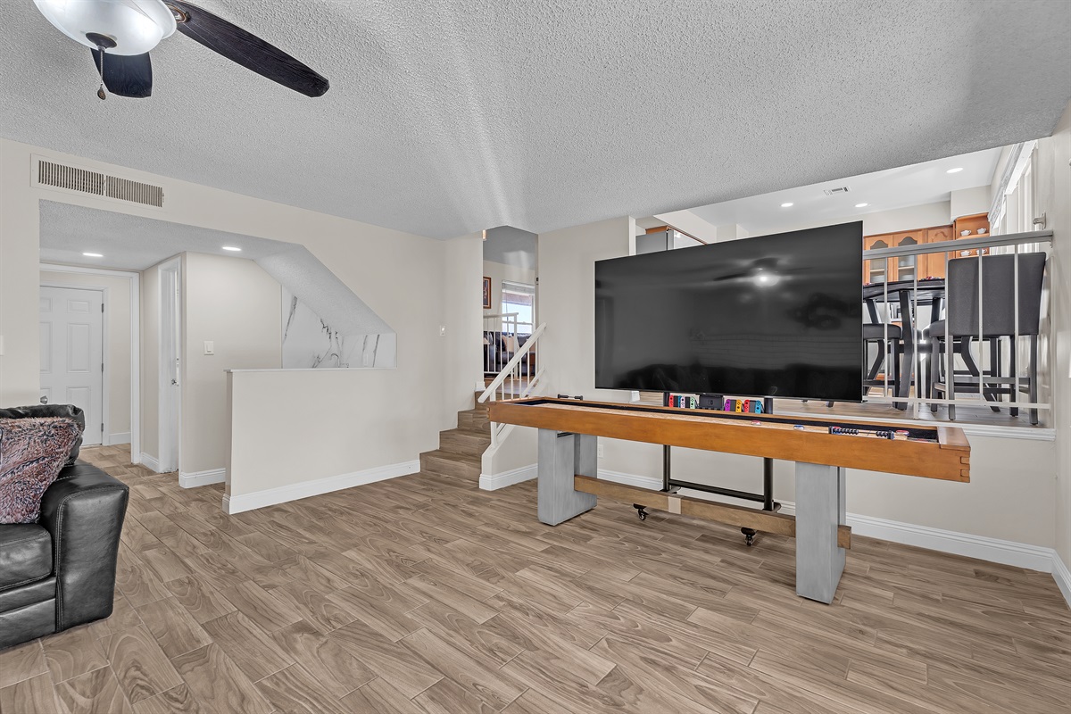 Living room 2 with 86 inch tv, shuffleboard, Nintendo switch, karaoke and bar sink