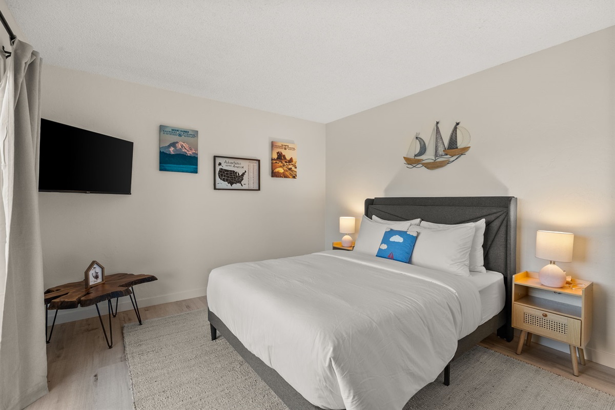 Cozy comfort meets convenience—enjoy a queen bed, TV, and calming views all in one space