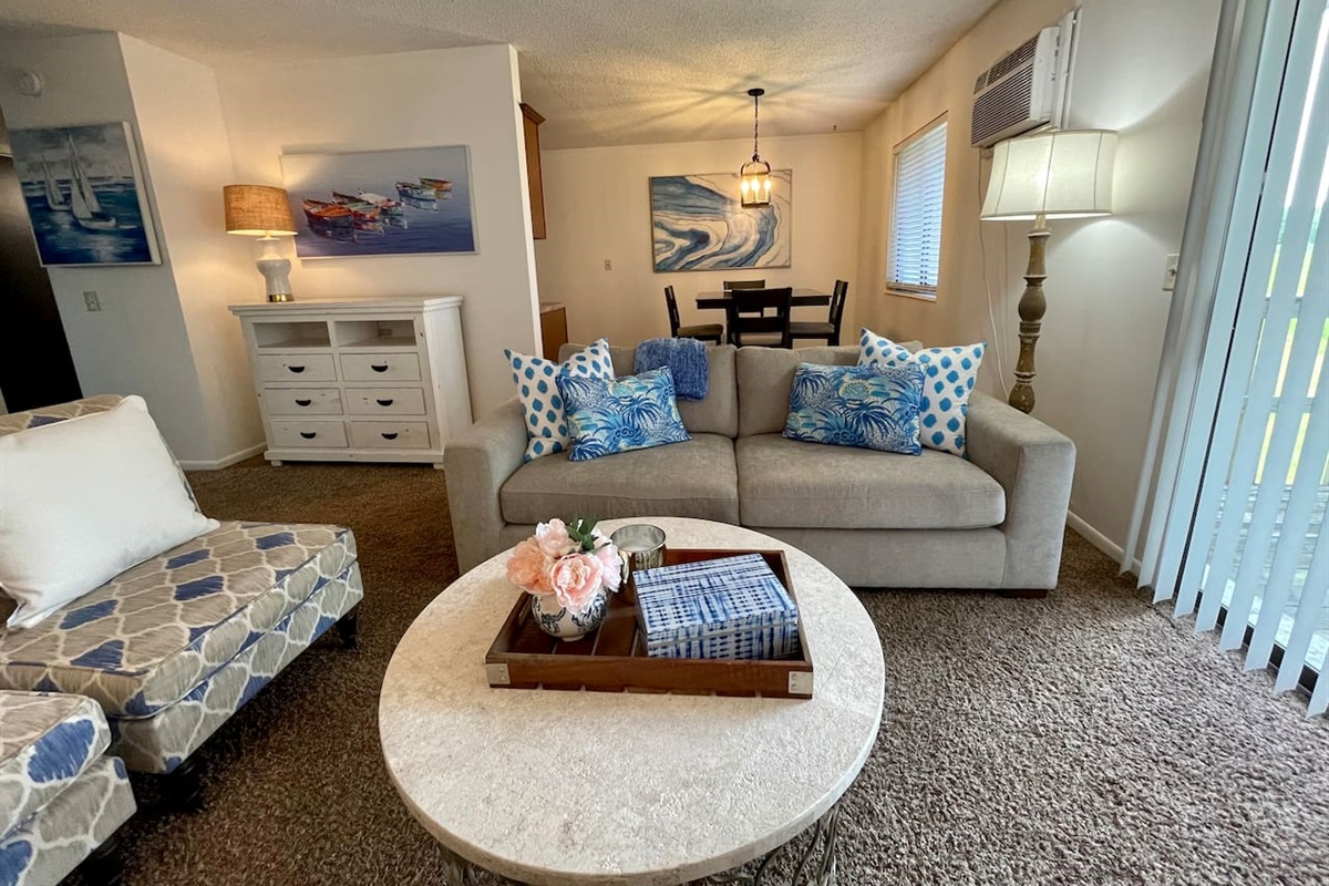 Coastal charm meets comfort in this inviting living and dining space, featuring beachy blue accents, plush seating, and a bright, airy vibe. Enjoy meals at the dining table or unwind in the lounge area—perfect for relaxing after a day of exploring.