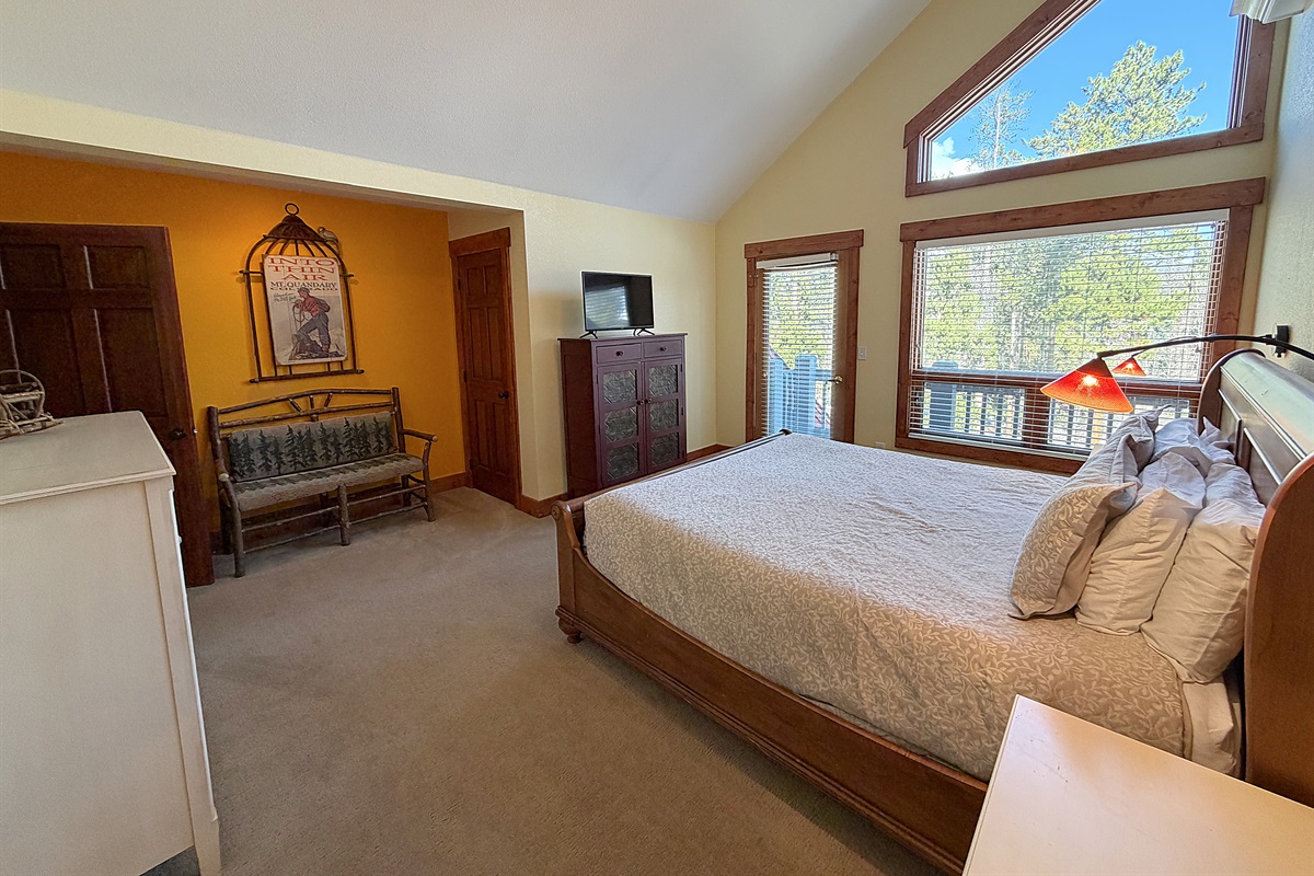 Large primary bedroom with King bed, attached full bathroom and private balcony.