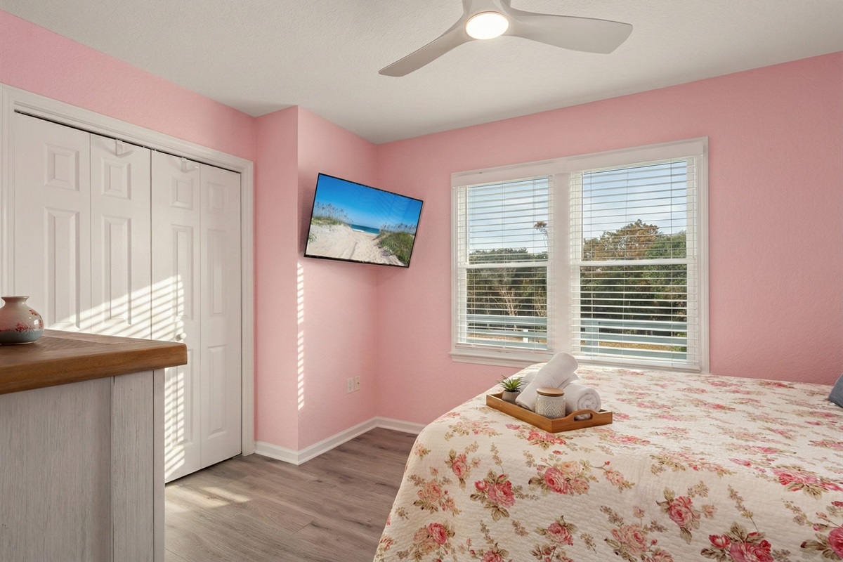 ML Bedroom 2 - Cheerful and inviting bedroom with a soft pink theme and charming décor.