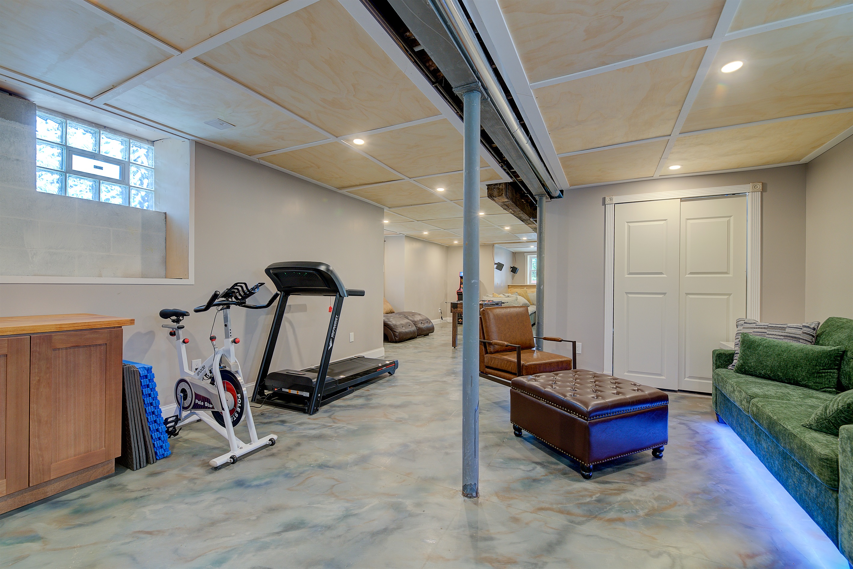 Rec room, with exercise equipment, arcade, 85" tv and a queen sofa bed