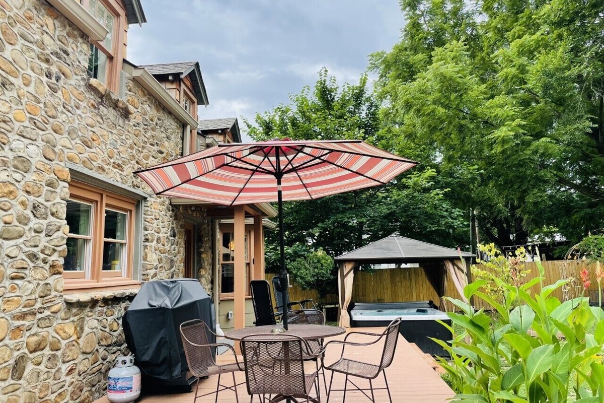 Deck out the back door with grill & table for taking a leisurely moment