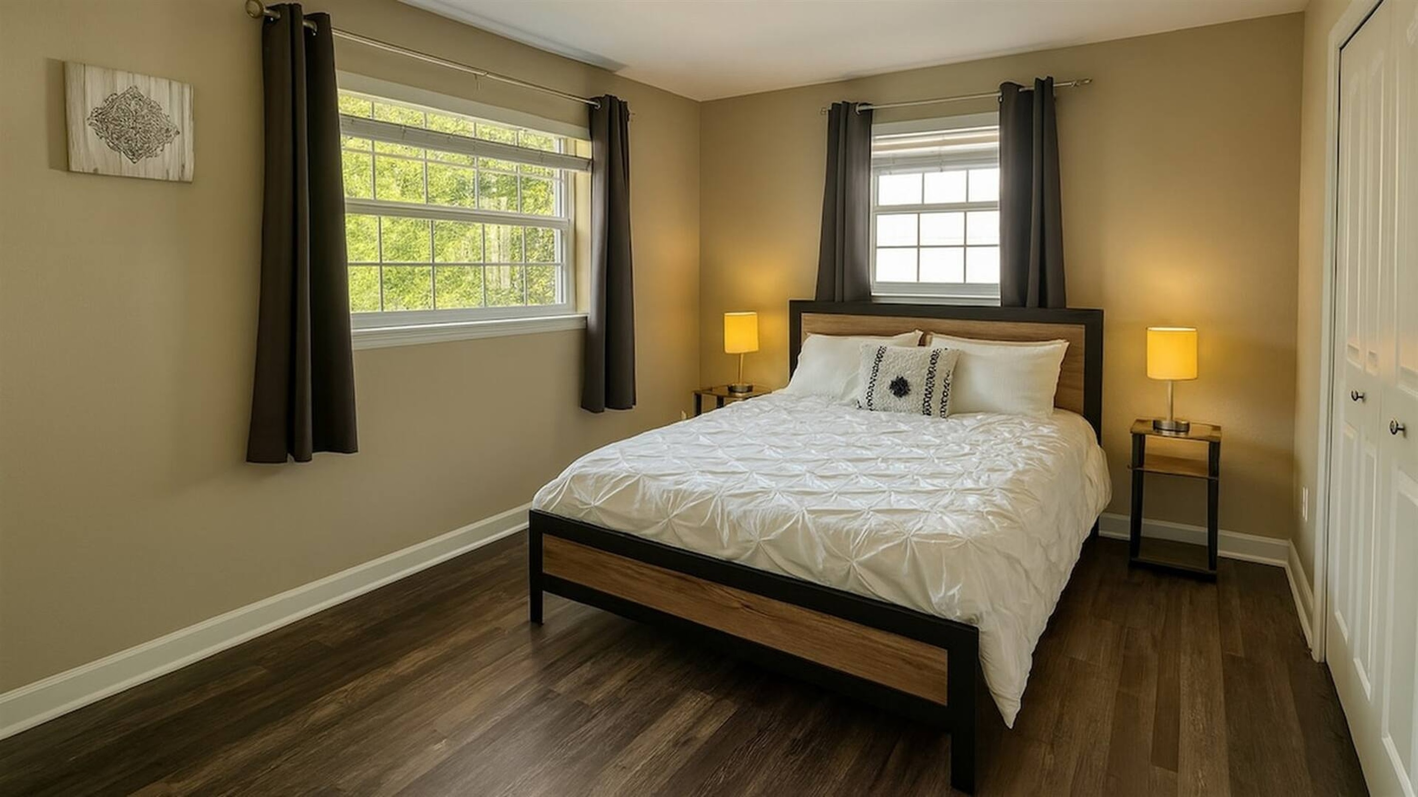 Bedroom 3 - Spacious bedroom with queen bed, dual windows, and ample natural lighting