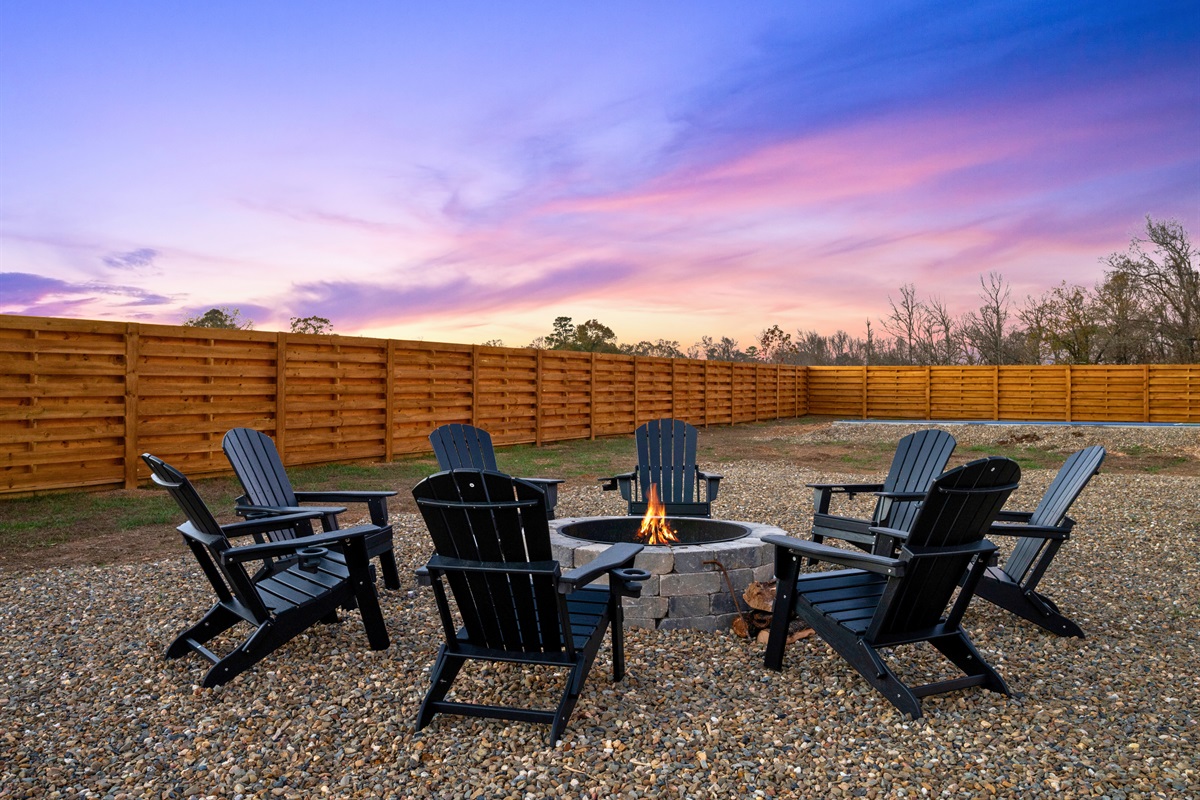 The fire pit sits perfectly in the open yard, giving you a peaceful spot to gather under the evening sky.