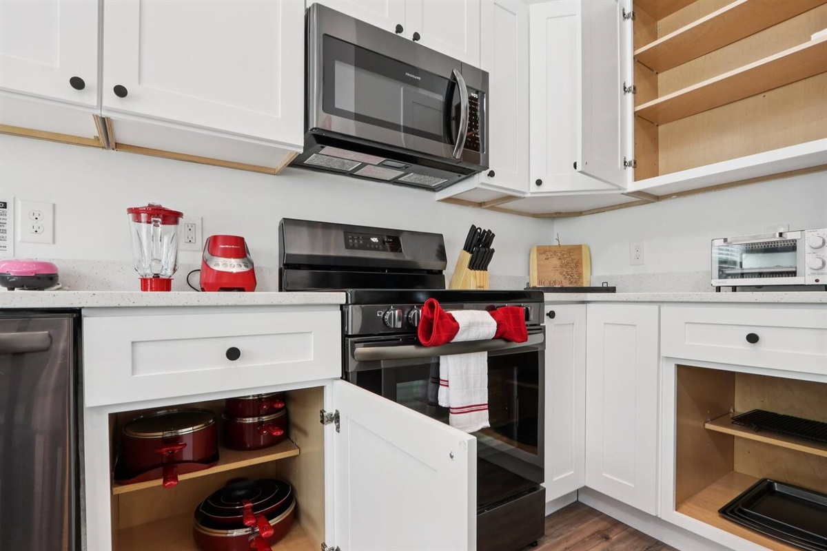 Coffee mugs with Keurig coffee maker (pods included), hot water heater, mini waffle maker, blender, stove, oven, dishwasher, fridge, filtered water, knives, cutting board, pots/pans, baking sheets, utensils.  