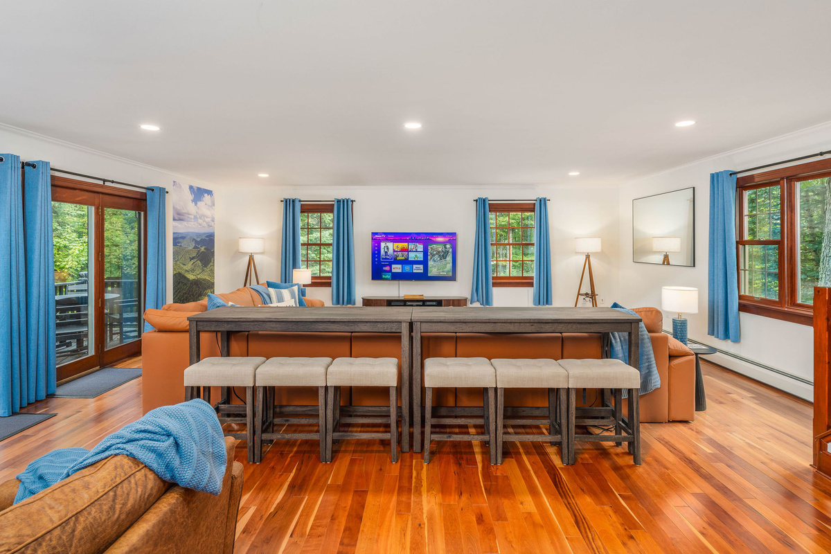 📺 Sectional seating for 6 plus bar-back seating for 6 more, all facing the 65" HDTV — everyone gets a seat for movie night.