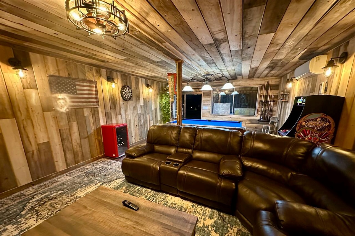 Seating area in game room, darts, mini fridge