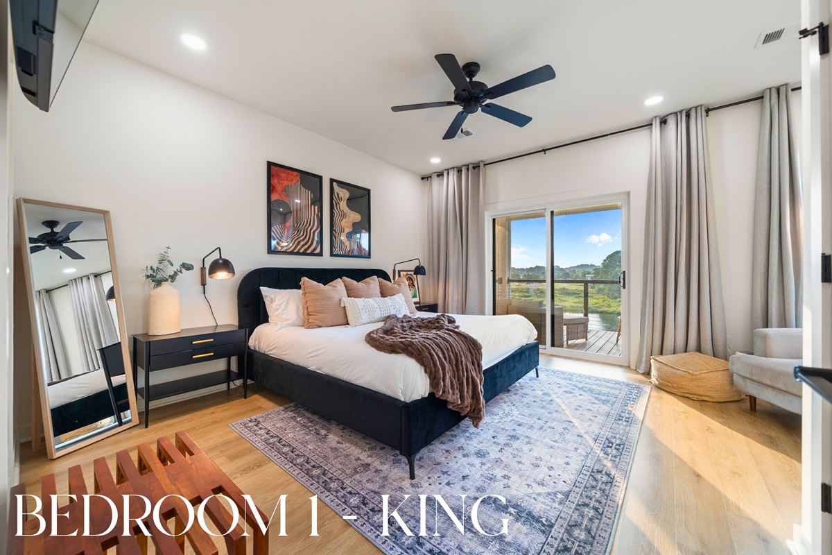 Bedroom 1: King suite with beautiful decor, private balcony access, and tranquil lake views.