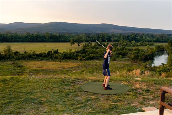 Challenge yourself to drive golf balls across the river toward the island below.