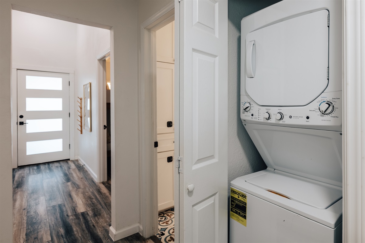 laundry room in hall way, with dryer and washer
