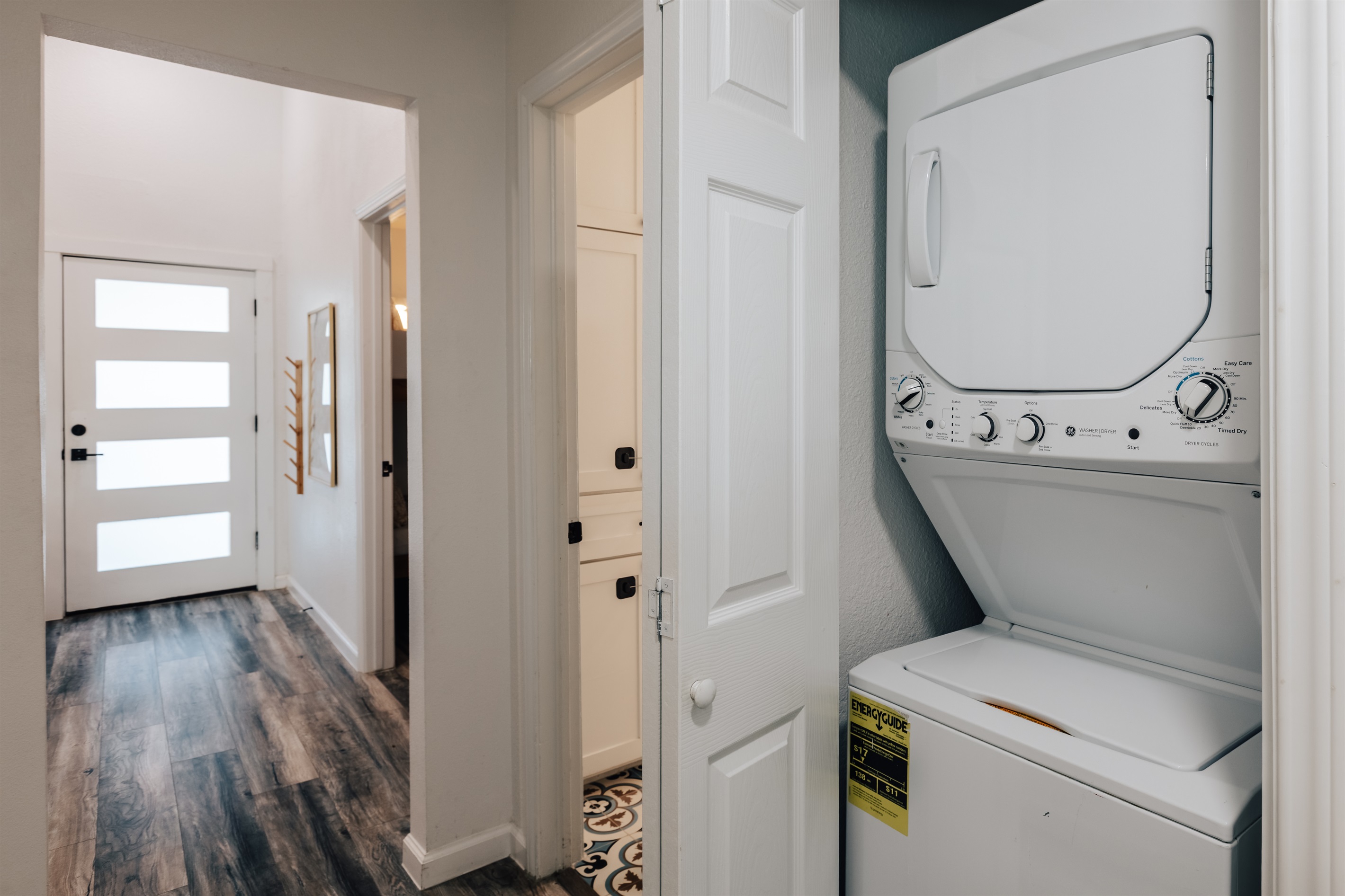 laundry room in hall way, with dryer and washer