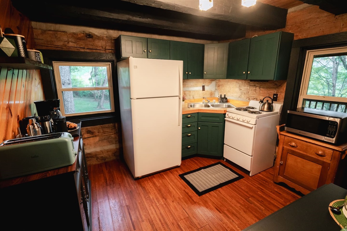 Kitchen with everything you need to prepare meals, full of cozy cabin charm.