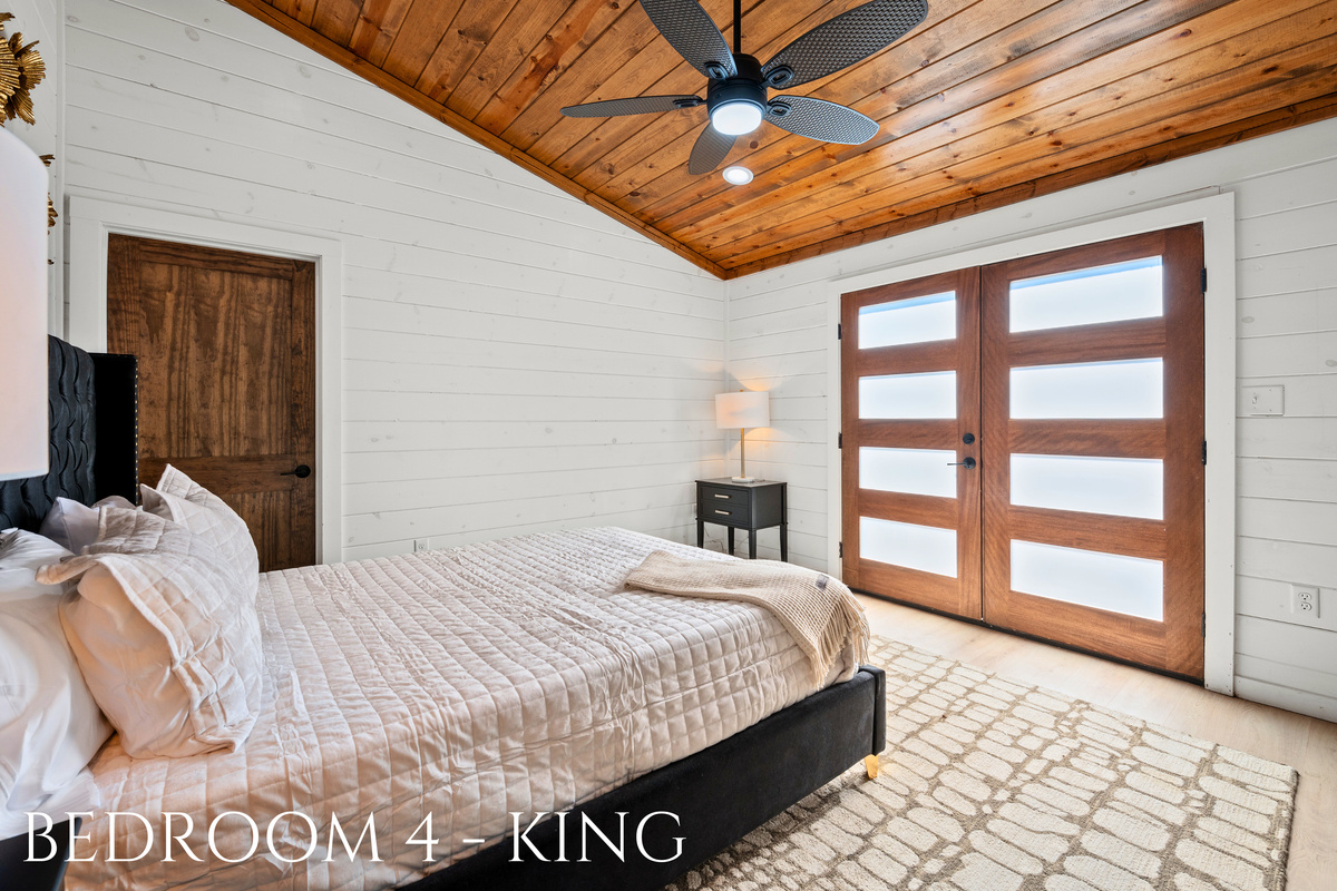 A welcoming king bedroom with warm wood ceilings, soft linens, and a peaceful atmosphere to help you recharge.