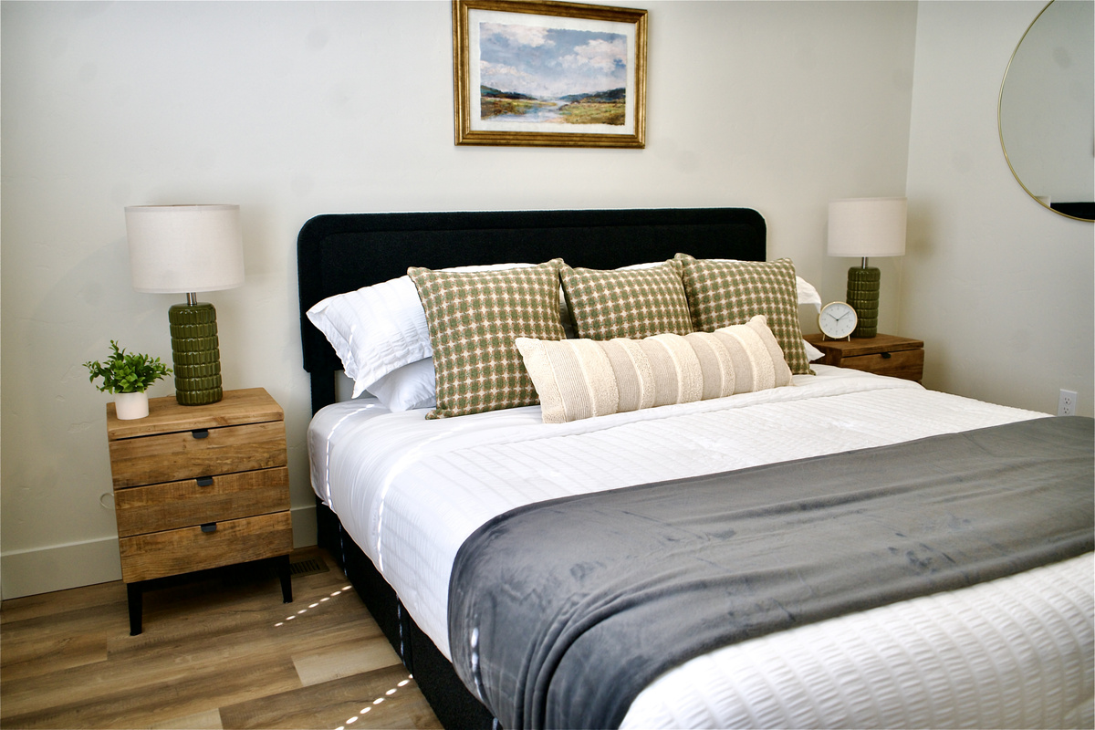 The fourth bedroom features bright, neutral tones that create a warm and inviting atmosphere, seamlessly complementing the home's thoughtfully designed interior. 