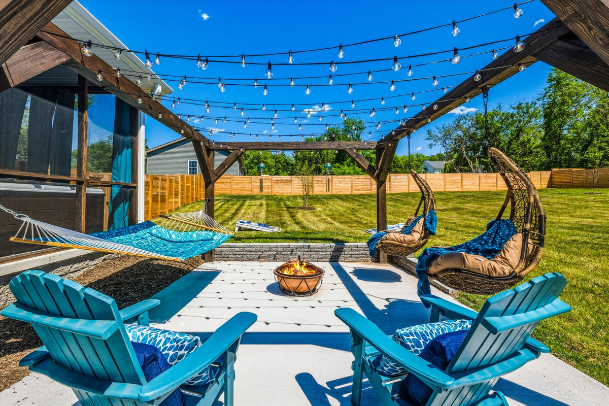 Adirondack chairs, string lights, and open skies create an atmosphere designed for slowing down.