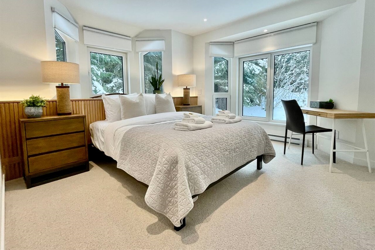 Bedroom #2 w/ Queen bed on 2nd floor features surround windows w/views of Fitzsimmons Creek & Excalibur Gondola which loads less than 300 meters to the south of this property's front door. 