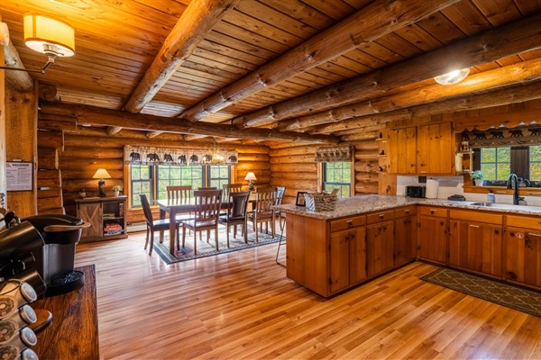 Fully equipped log cabin kitchen with dining area—ideal for cooking meals and sharing stories together