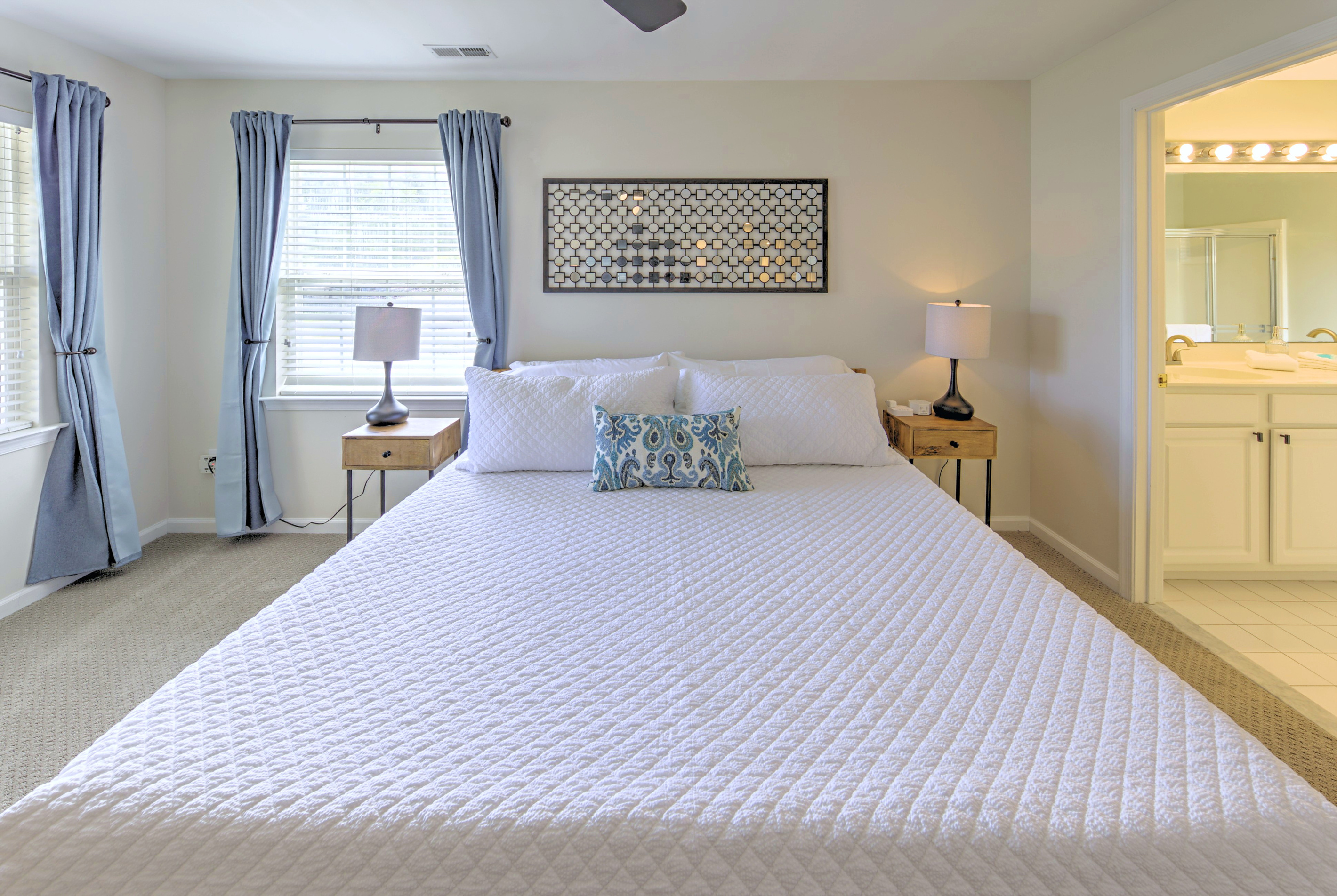 Fresh linens provided and beds professionally made before arrival—no linen rentals required.

Primary Bedroom: Bright and airy retreat with a king bed, cheerful decor, and blackout curtains with an ensuite bathroom and large closet! Perfect for relaxation.