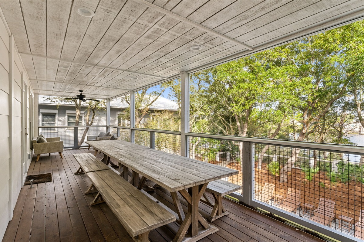 2nd Floor Back Deck: Dinner with a view! Enjoy al fresco dining on our spacious screened deck, overlooking the tranquil lake.
