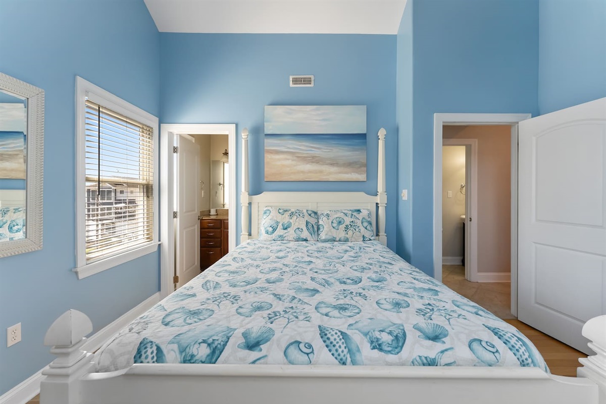 Queen size bed with private attached bathroom, HDTV, storage and ceiling fan. 