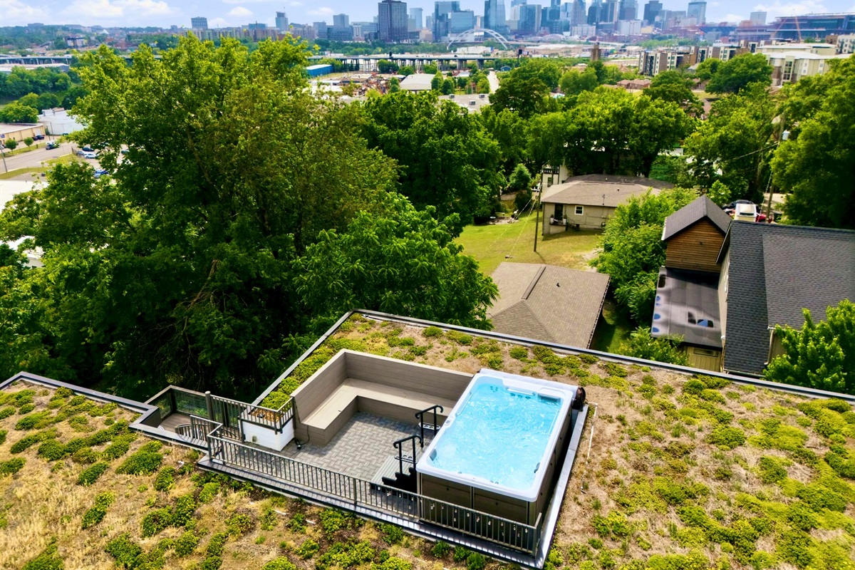 Rooftop hot tub w/ sweeping city skyline views — soak under the stars w/ the whole crew.

