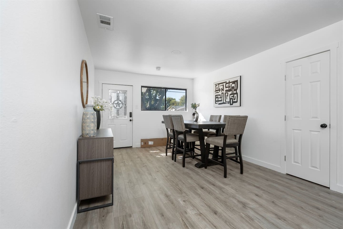Spacious dining room in the heart of the home. Enjoy meals, game nights, or remote work with a clear view of the living room and kitchen.