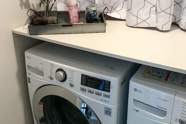 Walk-in Laundry room with front loading washer and dryer