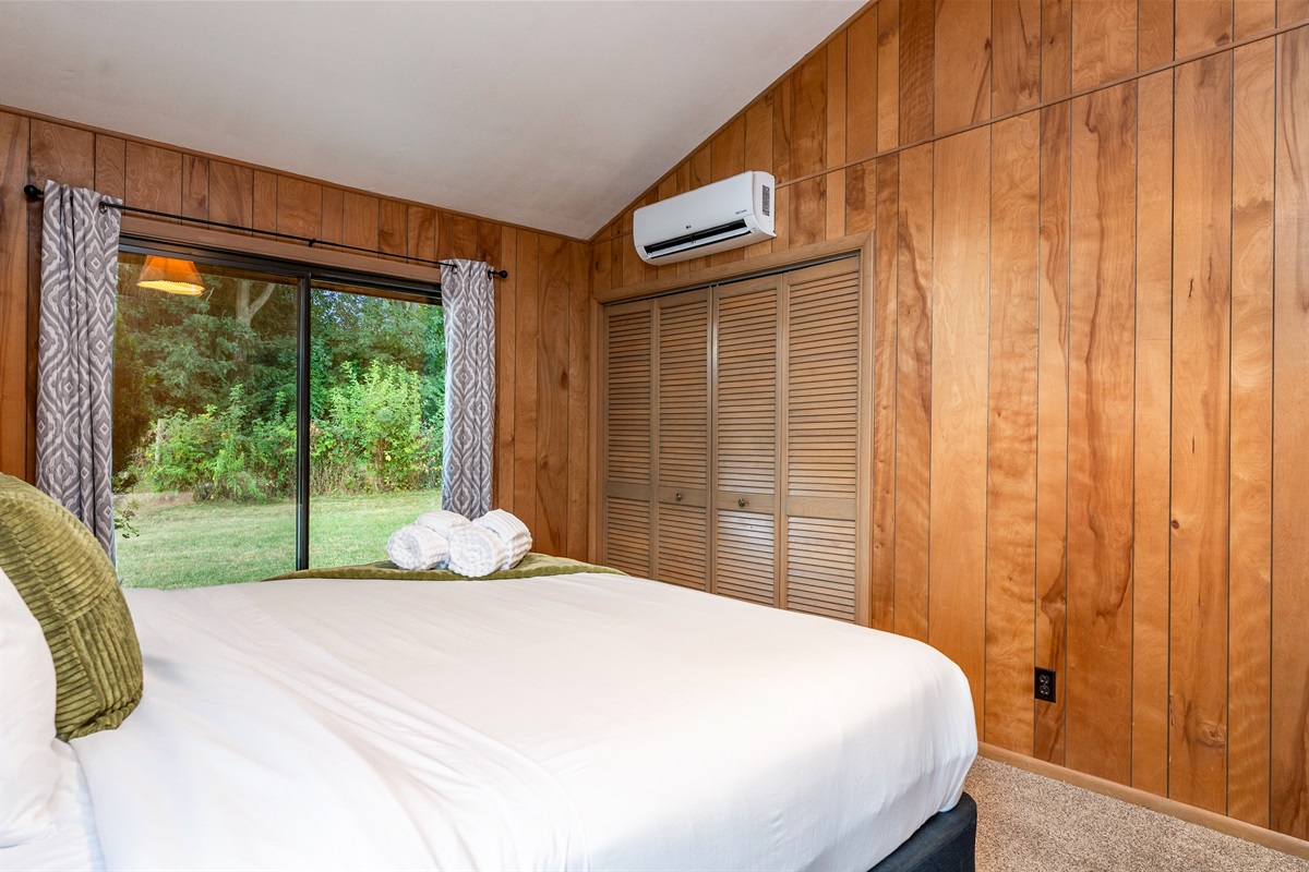 Comfortable guest room with outdoor access, ample closet space, and modern comfort touches.