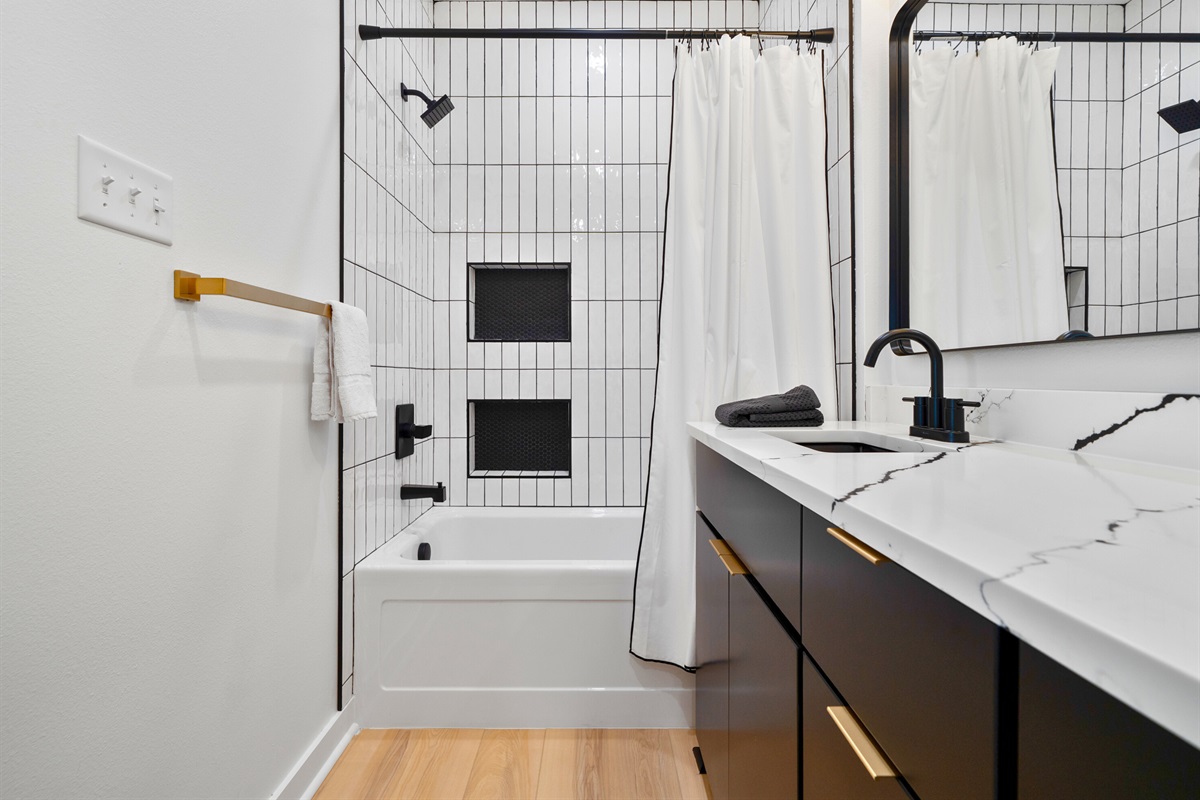 A tub and shower combination offers flexibility for different routines and preferences.