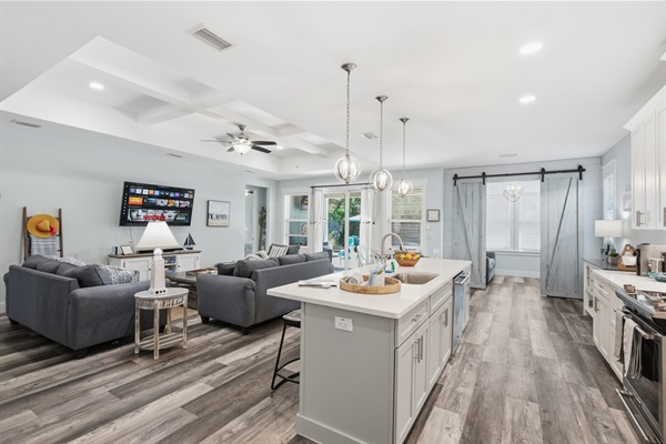 Huge open plan living room with a 9-foot ceilings, that opens up to your private back patio, and pool deck.