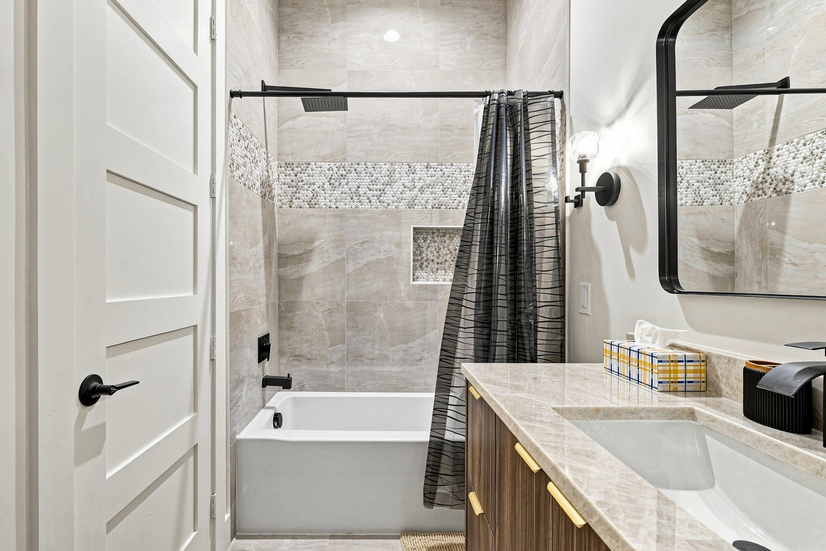 Experience sleek design with modern fixtures and a tranquil soaking tub!