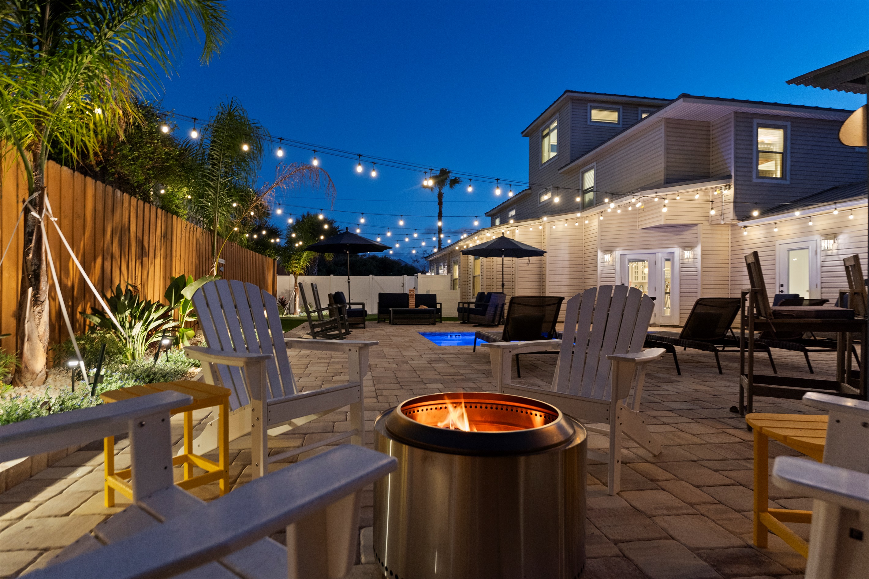 Tropical themed back yard with pool, fire ring, putting green, tiki hut and much more