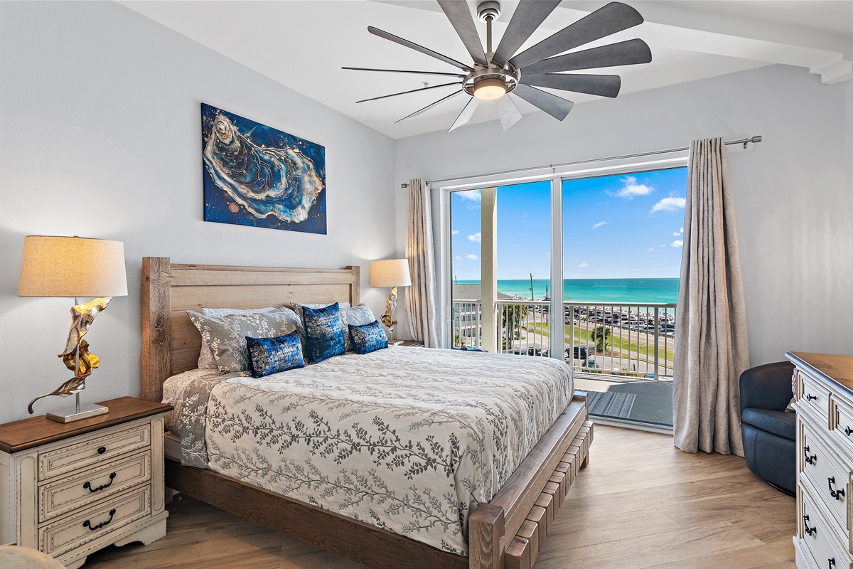 Gulf‑front master king bedroom with balcony access