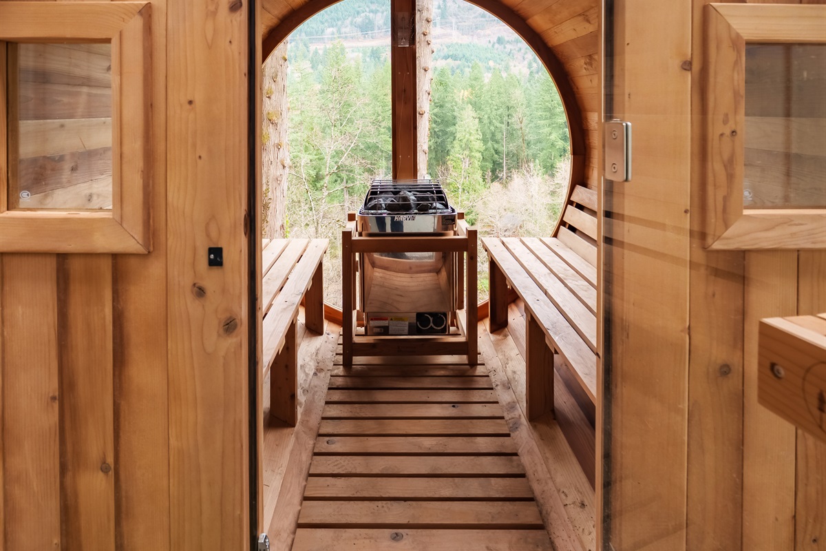 Step into your private cedar sauna and unwind with peaceful forest and mountain views—an intimate retreat that melts stress and elevates your stay at Emberwood Chalet.