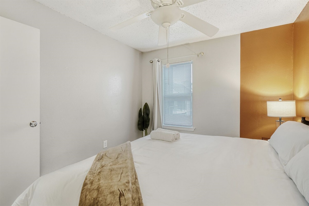 Cozy bedroom with warm tones and soft natural light.