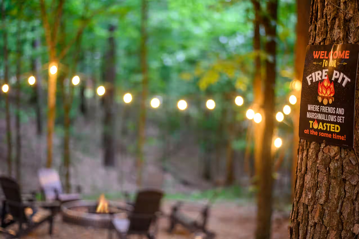 Fire Pit: Gather around for s'mores and stories beneath twinkling lights in the woods!